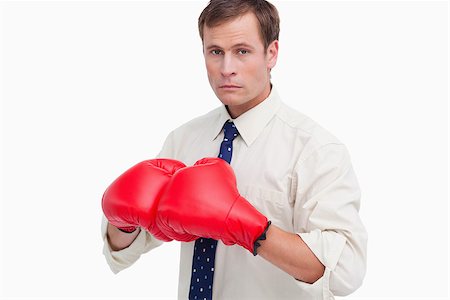 simsearch:400-05718453,k - Businessman with boxing gloves ready to fight against a white background Stock Photo - Budget Royalty-Free & Subscription, Code: 400-06686869