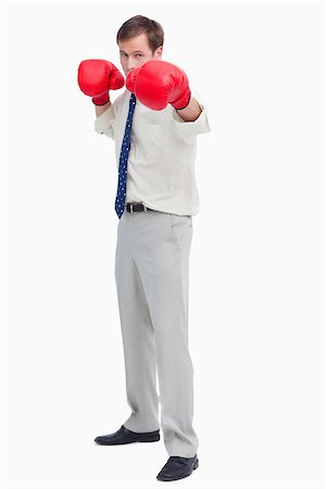 simsearch:400-05718453,k - Businessman with boxing gloves in offensive position against a white background Stock Photo - Budget Royalty-Free & Subscription, Code: 400-06686870