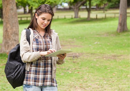 students tablets outside - Young female student using a tactile tablet in a park Stock Photo - Budget Royalty-Free & Subscription, Code: 400-06687991