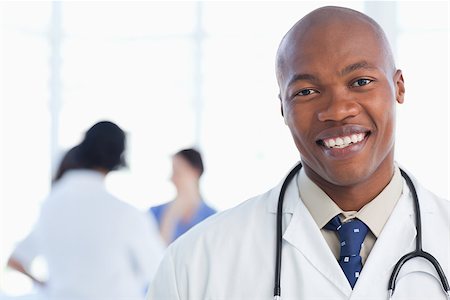 Young doctor standing with his stethoscope around his neck Stock Photo - Budget Royalty-Free & Subscription, Code: 400-06688526
