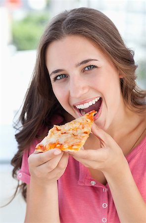 eat mouth closeup - A woman looking at the camera in front of her as she is about to eat her pizza Stock Photo - Budget Royalty-Free & Subscription, Code: 400-06688542