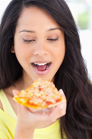 eat mouth closeup - A close up shot of a woman with a pizza slice as she is about to eat it while looking at it Stock Photo - Budget Royalty-Free & Subscription, Code: 400-06688551