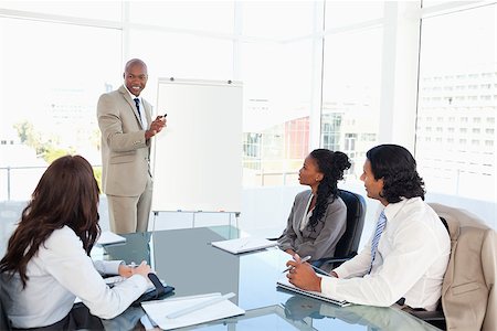 Executive giving a presentation in front of his co-workers Stock Photo - Budget Royalty-Free & Subscription, Code: 400-06688575