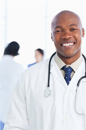 Young intern showing a beaming smile in front of his medical team Stock Photo - Budget Royalty-Free & Subscription, Code: 400-06688585