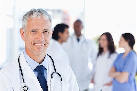 Smiling doctor waiting for his team while standing upright Stock Photo - Budget Royalty-Free & Subscription, Code: 400-06688592