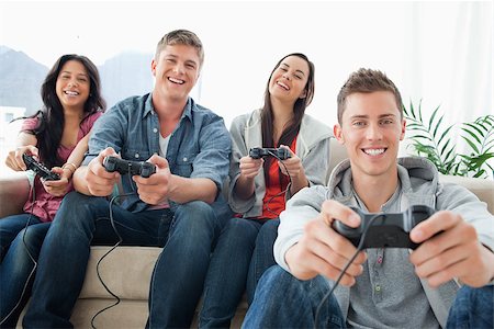 A group of friends playing games and laughing sit in front of the camera Stock Photo - Budget Royalty-Free & Subscription, Code: 400-06688718