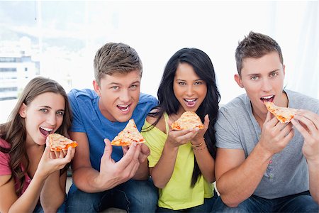 friends and eat and pizza - A smiling group with mouths open about to eat pizza as they look at the camera Stock Photo - Budget Royalty-Free & Subscription, Code: 400-06688875