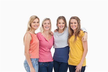 simsearch:400-06634629,k - Four smiling friends as they stand beside one another Fotografie stock - Microstock e Abbonamento, Codice: 400-06688910