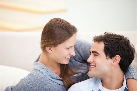 Couple looking each other while embracing in a sitting room Stock Photo - Budget Royalty-Free & Subscription, Code: 400-06689086