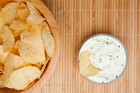 simsearch:400-06689258,k - A bowl of chips and a bowl of white dip with herbs side by side Stock Photo - Budget Royalty-Free & Subscription, Code: 400-06689094