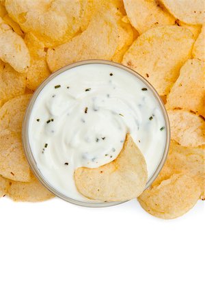 simsearch:400-06689258,k - Close up of a bowl of dip with herbs ans a nacho dipped in it against a white background Stock Photo - Budget Royalty-Free & Subscription, Code: 400-06689092