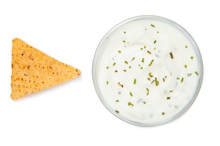 simsearch:400-06689258,k - Bowl of dip with herbs beside a nacho against a white background Stock Photo - Budget Royalty-Free & Subscription, Code: 400-06689258