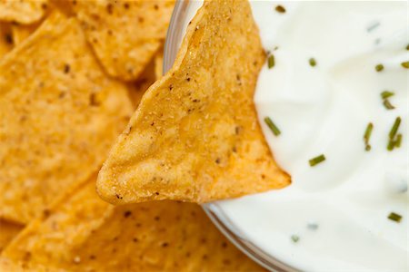 simsearch:400-06689258,k - Close up of a nacho dipped into a bowl of dip with herbs Stock Photo - Budget Royalty-Free & Subscription, Code: 400-06689267
