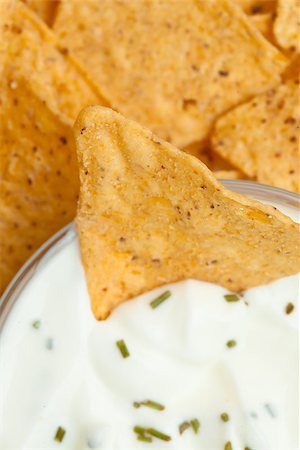 simsearch:400-06689258,k - Close up of a bowl of white dip with herbs and a nacho dipped in it Stock Photo - Budget Royalty-Free & Subscription, Code: 400-06689269