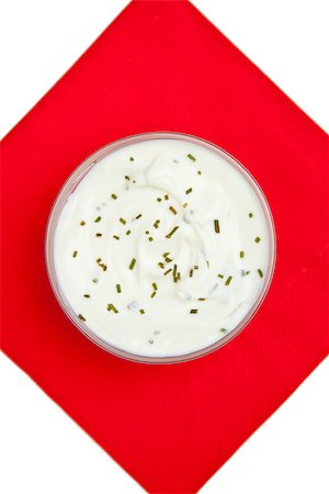 simsearch:400-06689258,k - Close up of a bowl of white dip with herbs on a red napkin against a white background Stock Photo - Budget Royalty-Free & Subscription, Code: 400-06689261