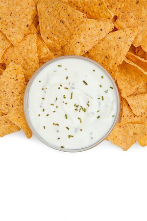 simsearch:400-06689258,k - Close up of a bowl of dip with herbs surrounded by nachos against a white background Stock Photo - Budget Royalty-Free & Subscription, Code: 400-06689263