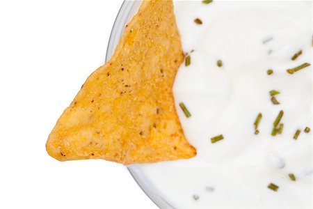 simsearch:400-06689258,k - A nacho dipped into a bowl of white dip with herbs against a white background Stock Photo - Budget Royalty-Free & Subscription, Code: 400-06689270