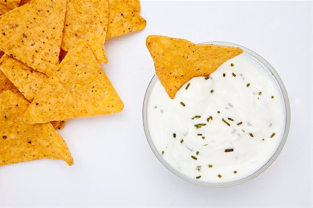 simsearch:400-06689258,k - Bowl of dip with herbs with a nacho dipped in it against a white background Stock Photo - Budget Royalty-Free & Subscription, Code: 400-06689273