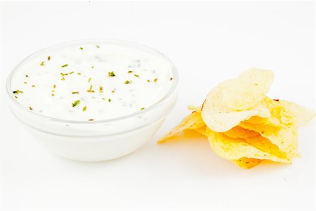 simsearch:400-06689258,k - Bowl of a white dip with herbs and chips against white background Stock Photo - Budget Royalty-Free & Subscription, Code: 400-06689294