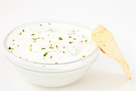 simsearch:400-06689258,k - Bowl of white dip with herbs and a chips against a white background Stock Photo - Budget Royalty-Free & Subscription, Code: 400-06689293