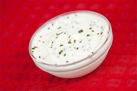simsearch:400-06689258,k - Bowl of white dip with herbs on a red tablecloth Stock Photo - Budget Royalty-Free & Subscription, Code: 400-06689303