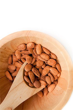 simsearch:400-09080000,k - Wooden spoon with almonds in a bowl against a white background Stock Photo - Budget Royalty-Free & Subscription, Code: 400-06689315