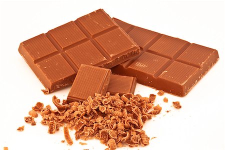 Bars of chocolate and chocolate shavings against a white background Stock Photo - Budget Royalty-Free & Subscription, Code: 400-06689397