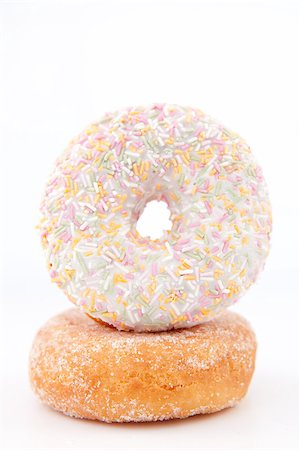 doughnut background - Doughnut with multi coloured icing sugar against a white back ground Stock Photo - Budget Royalty-Free & Subscription, Code: 400-06689528