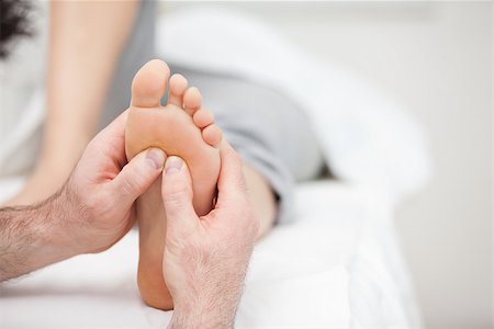 Foot being massaged on a medical table in a room Stockbilder - Microstock & Abonnement, Bildnummer: 400-06689753