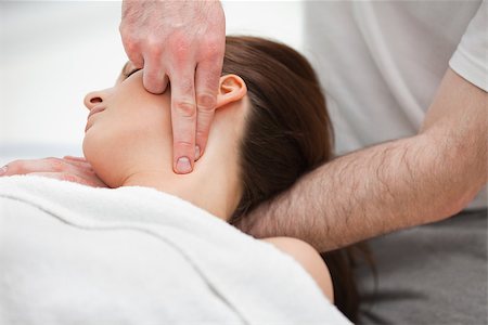 Doctor manipulating the neck of a woman while using his fingertips indoors Stock Photo - Budget Royalty-Free & Subscription, Code: 400-06689778