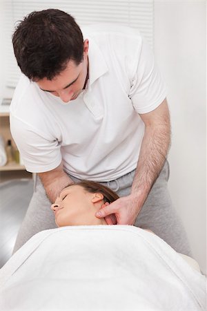 Therapist manipulating the neck of his patient while standing in a room Stock Photo - Budget Royalty-Free & Subscription, Code: 400-06689839