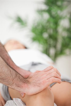 Serious doctor pressing on the knee of a woman indoors Stock Photo - Budget Royalty-Free & Subscription, Code: 400-06689890