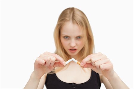 Angry woman braking a cigarette against white background Foto de stock - Super Valor sin royalties y Suscripción, Código: 400-06689947