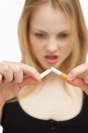 Woman braking a cigarette against white background Foto de stock - Super Valor sin royalties y Suscripción, Código: 400-06689943