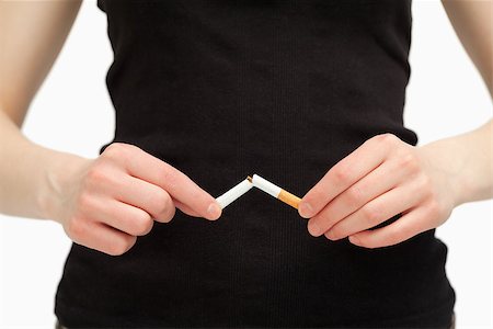 Close up of hands breaking a cigarette against white background Photographie de stock - Aubaine LD & Abonnement, Code: 400-06689950