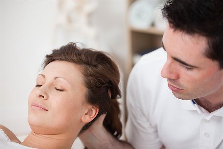 A doctor massaging the head of his patient while holding it in a room Stock Photo - Budget Royalty-Free & Subscription, Code: 400-06689996