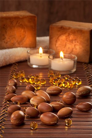 essence - seeds of argan with yellow cosmetic pearl,light and soap Stock Photo - Budget Royalty-Free & Subscription, Code: 400-06694073