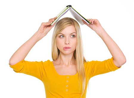 Confused student girl with raised book over head Stock Photo - Budget Royalty-Free & Subscription, Code: 400-06694893