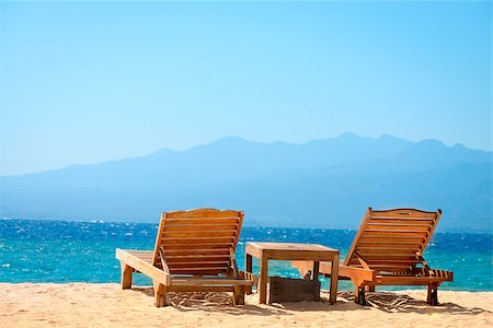 simsearch:400-06914796,k - Beach chairs on perfect tropical yellow sand beach with blue sea and island on background, Gili, Bali, Indonesia Stock Photo - Budget Royalty-Free & Subscription, Code: 400-06694998