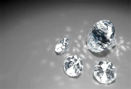 diamond sparkle - a closeup of a group of three small diamonds and a bigger one are lying down on a grey surface with some reflections of light around them Stock Photo - Budget Royalty-Free & Subscription, Code: 400-06695150