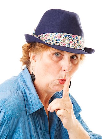 Middle-aged woman putting her finger to her lips in a hushing gesture.  Isolated on white. Foto de stock - Super Valor sin royalties y Suscripción, Código: 400-06695221