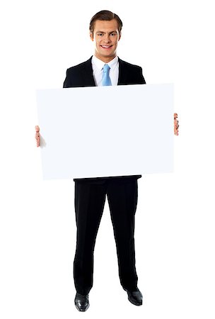 simsearch:400-05368656,k - Portrait of smiling young businessman showing blank signboard Stockbilder - Microstock & Abonnement, Bildnummer: 400-06695503