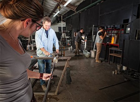 Four men and women busy in a glass making workshop Stock Photo - Budget Royalty-Free & Subscription, Code: 400-06696173