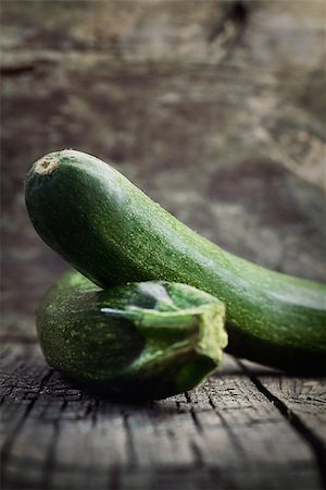 Vegetables background. Fresh green zucchini  on wood in vintage setting Stock Photo - Budget Royalty-Free & Subscription, Code: 400-06696329