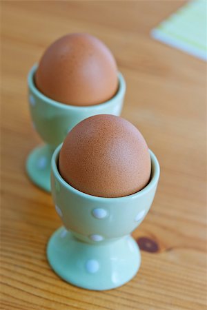 simsearch:400-04992703,k - Two breakfast eggs in the egg cups on the wooden table Stock Photo - Budget Royalty-Free & Subscription, Code: 400-06697109