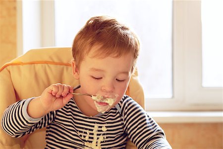 porage - Portrait of two year old boy eating porridge in the morning. Stock Photo - Budget Royalty-Free & Subscription, Code: 400-06697977