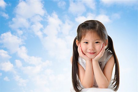 simsearch:400-05739745,k - Young Asian girl with smile on her face sitting outdoor in summer day, blue sky background Stock Photo - Budget Royalty-Free & Subscription, Code: 400-06697998