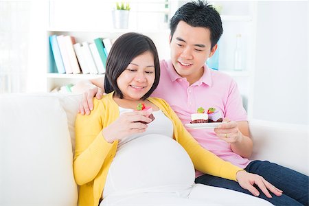 fat people eating at home - Young Asian pregnant woman and husband eating sweet cake at home Stock Photo - Budget Royalty-Free & Subscription, Code: 400-06698019