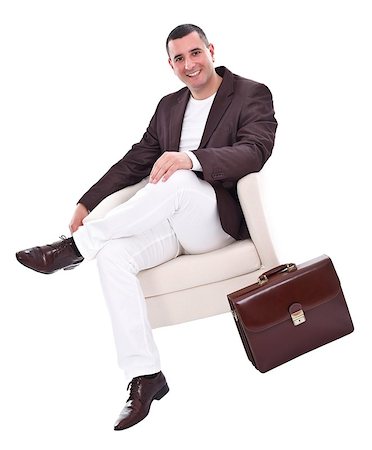 simsearch:400-04173616,k - Businessman in elegant suit sitting in armchair, studio shot Stockbilder - Microstock & Abonnement, Bildnummer: 400-06698388