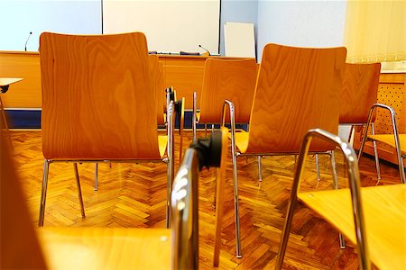 Conference room with rows of wooden chairs with desk and small front table Stock Photo - Budget Royalty-Free & Subscription, Code: 400-06699437